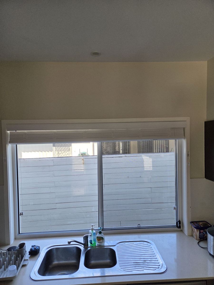 Kitchen window with an old blind, before