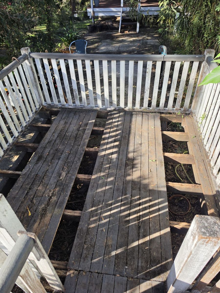 Old deck with missing and rotted boards, before