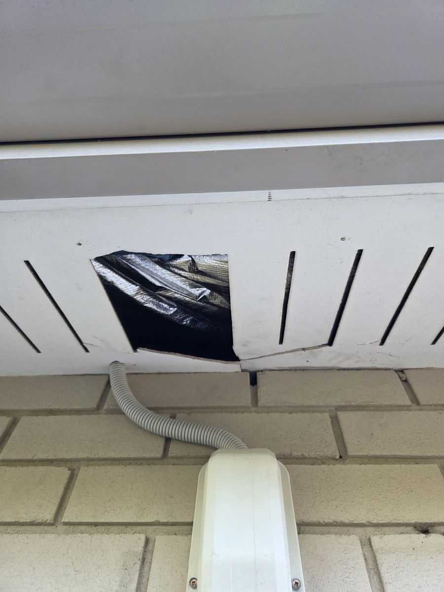 Broken hole in an eave lining, before