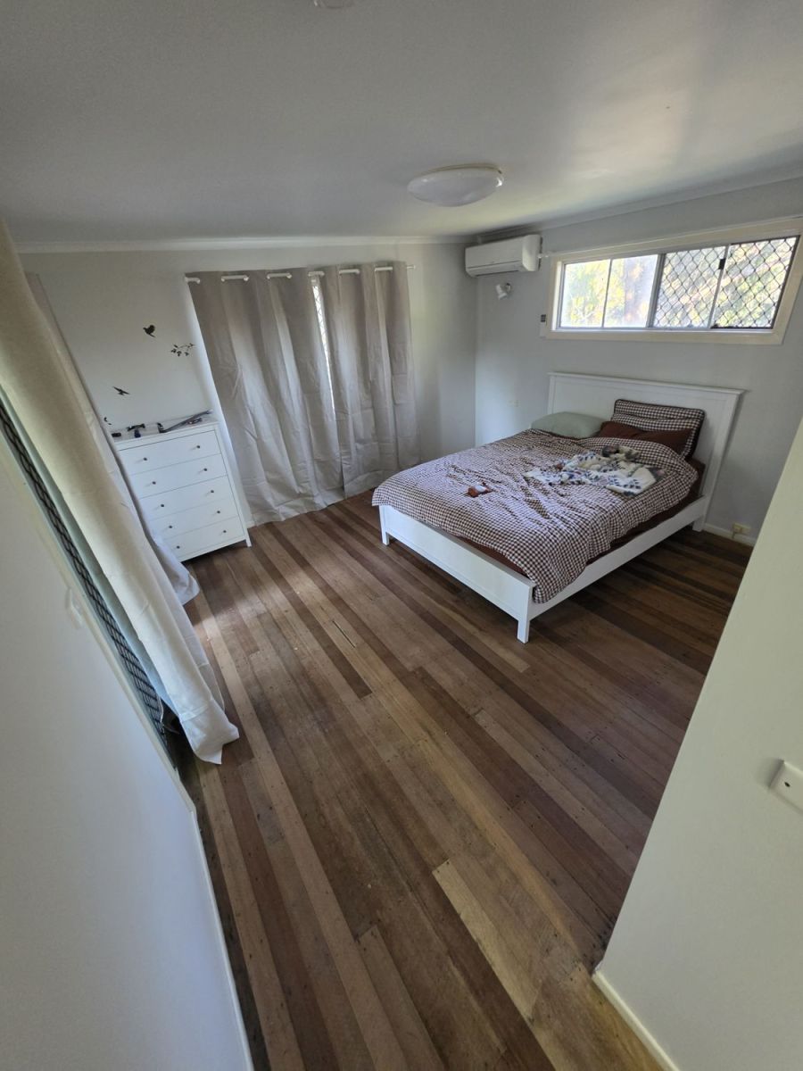 Bedroom with the timber floor cleaned up and furniture back in