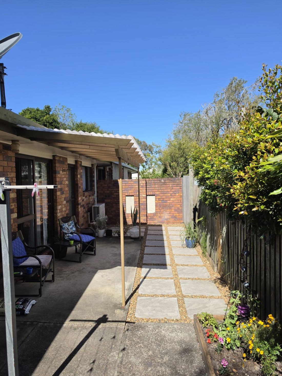 Finished paver path with gravel border down the side of the house