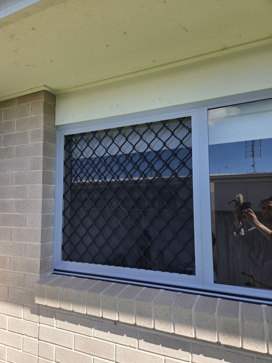 Security screens fitted to a brick house window